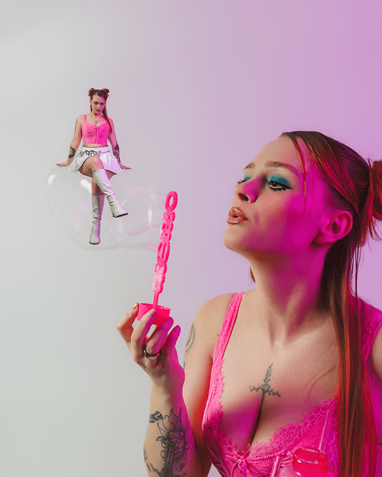 A model blowing a bubble with a pink outfit