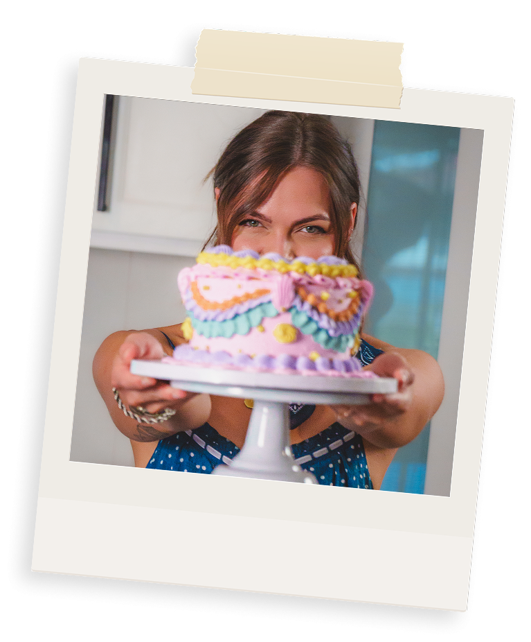 Woman holding a colorful cake in Fayetteville AR.